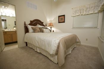 a bedroom with a bed and a sink in a room